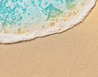 Top view of beach water meeting sand
