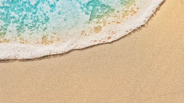Top view of beach water meeting sand